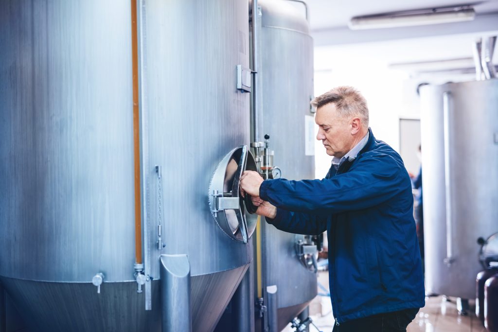man working with brewery equipment producing craft 2026 01 09 07 09 15 utc